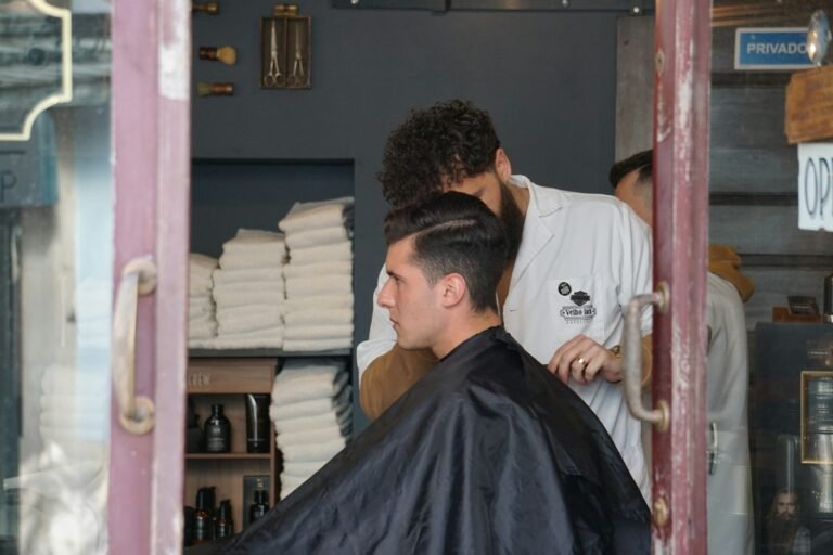 man in white shirt sitting on barber chair